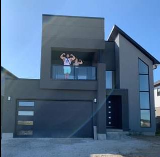 Regan Grimes and his wife Victoria D'Ariano in their new house.