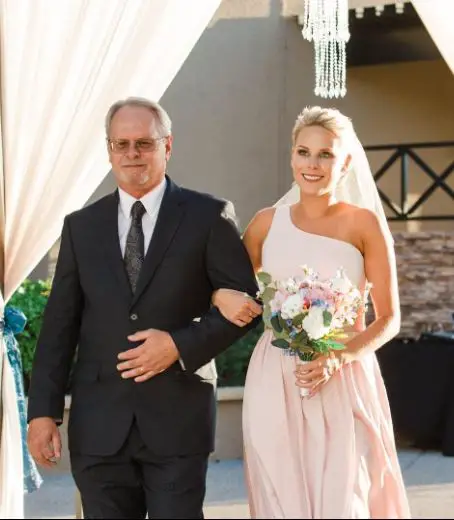 Amber Wheeler with her father on her wedding aisle